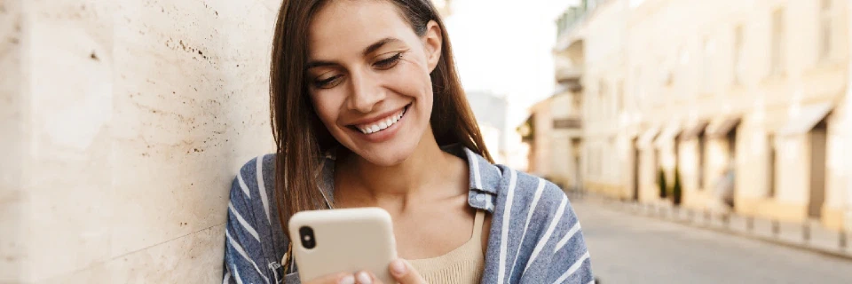 Girl smiling at phone typing